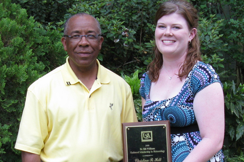 Richard Benjamin (left) of ExxonMobil presents the ExxonMobil Scholarship Award to Christina Holt, the 2008 outstanding junior in meteorology.