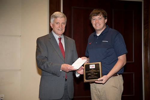 Dr. Bill Williams presents an Endowment Scholarship to Dillon Blount.