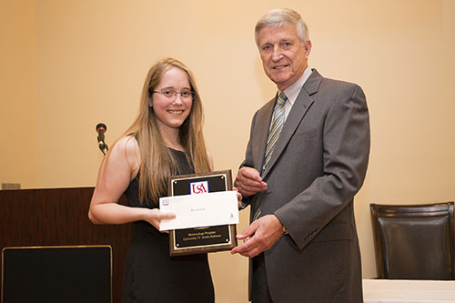 Dr. Bill Williams presents an Endowment Scholarship to Kaia White.