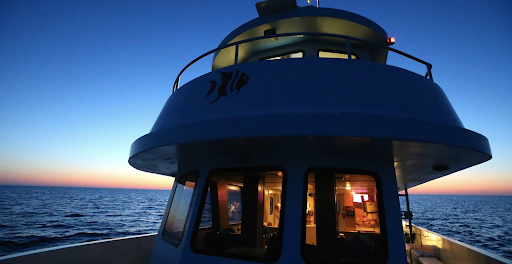 Boat on the water at night.