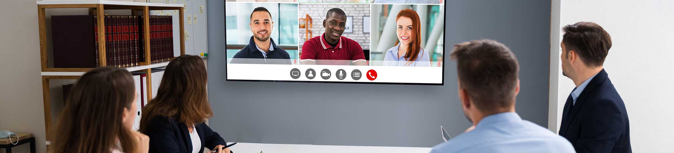 A table looking at a screen for a zoom meeting.