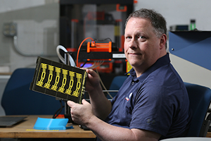 Professor working on technology equipment