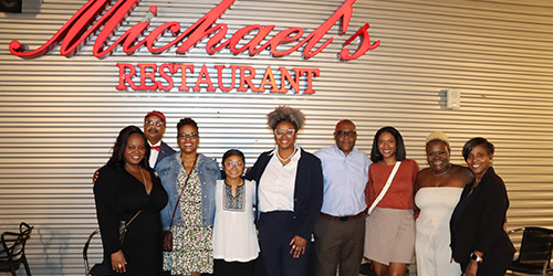 Group of Black Alumni Society members in front of Michael's Restaurant.