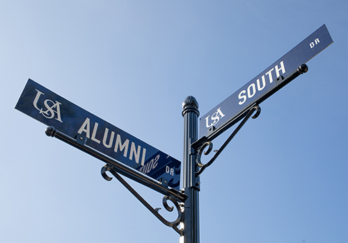 Alumni and South street signs.