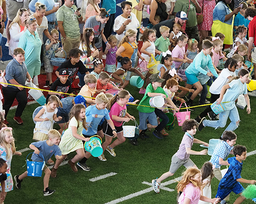 Kids running to start Alumni Easter Egg Hunt.