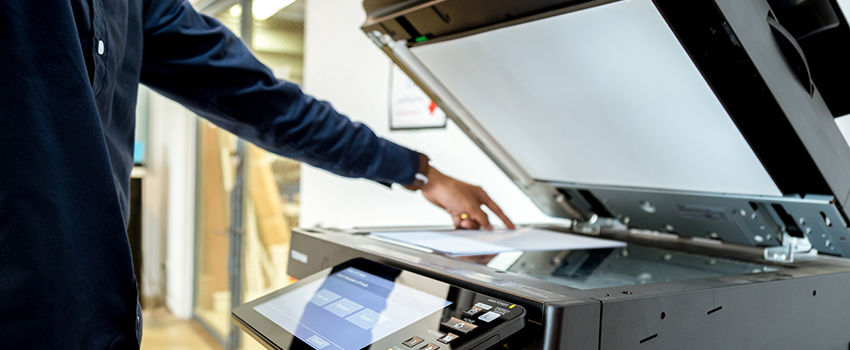 Person making a copy at the copier machine.