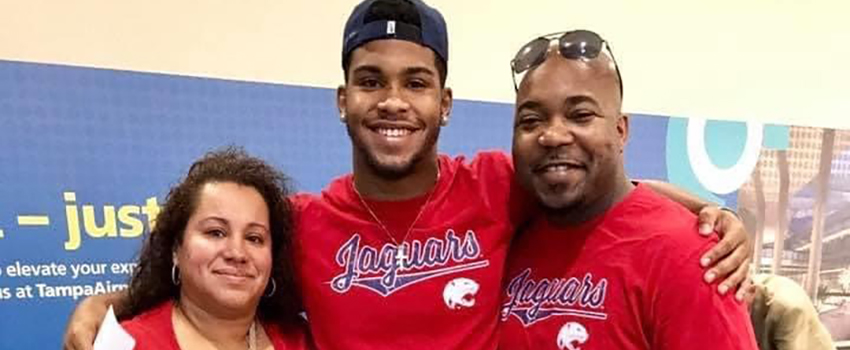 Parents with student in airport with jags shirts on.