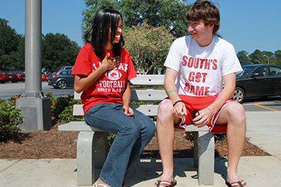 Two students sitting on bench