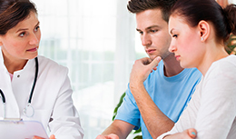 A doctor talking to two patients